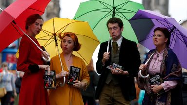 Performers hand out flyers on the The Royal Mile trying to attract people to their show, in Edinburgh, Scotland, in August 2019